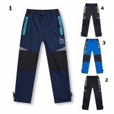 KUGO D915 zateplené šusťákové kalhoty 98-128